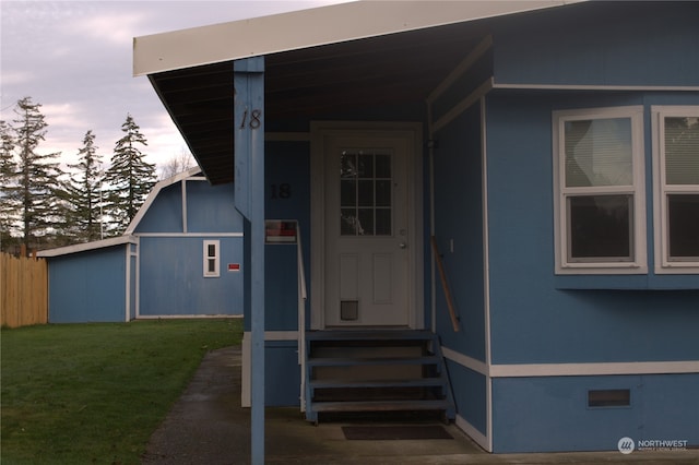 exterior entry at dusk with a yard