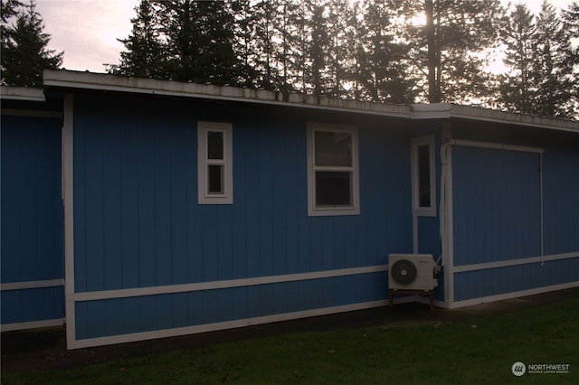 property exterior at dusk featuring ac unit