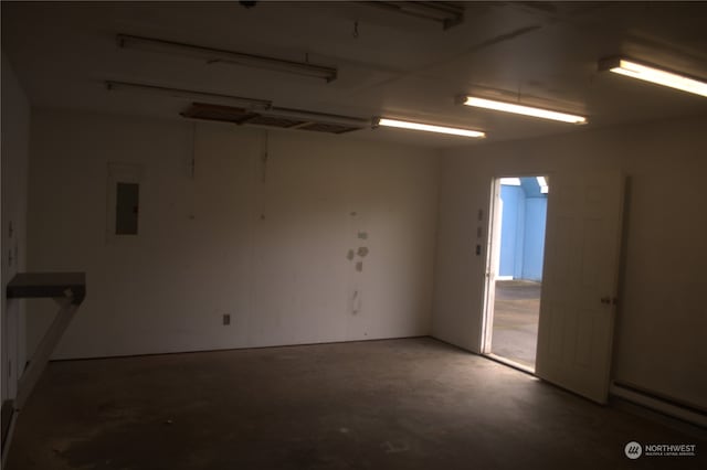 unfurnished room featuring baseboard heating, electric panel, and concrete floors