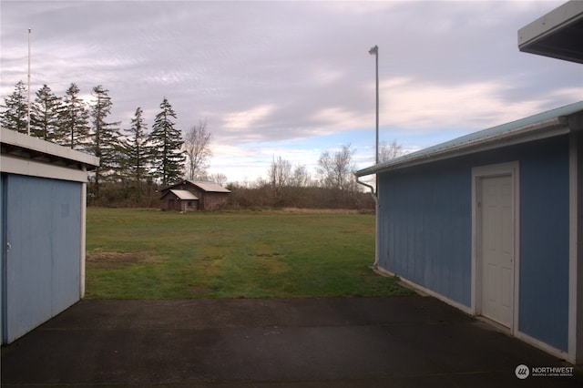 yard at dusk with a patio