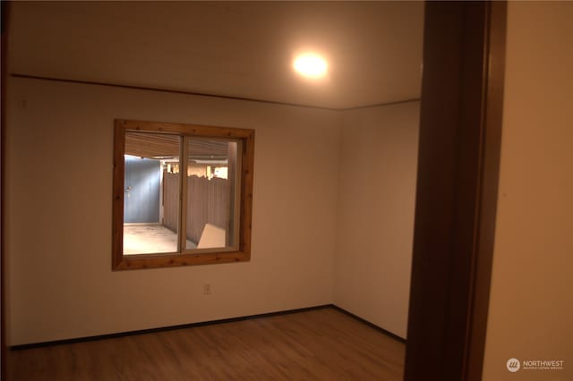 unfurnished room with hardwood / wood-style flooring