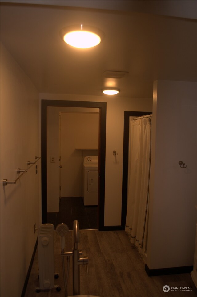 hall with washer / dryer, radiator heating unit, and dark wood-type flooring