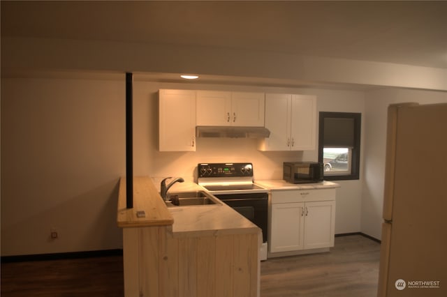 kitchen with white cabinetry, sink, electric range oven, dark hardwood / wood-style floors, and white fridge