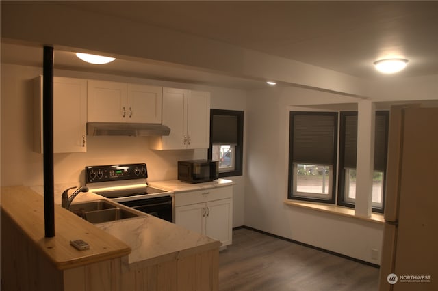 kitchen featuring black appliances, white cabinets, sink, dark hardwood / wood-style flooring, and kitchen peninsula