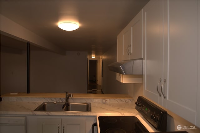 kitchen featuring dishwasher, sink, light stone counters, stove, and white cabinets