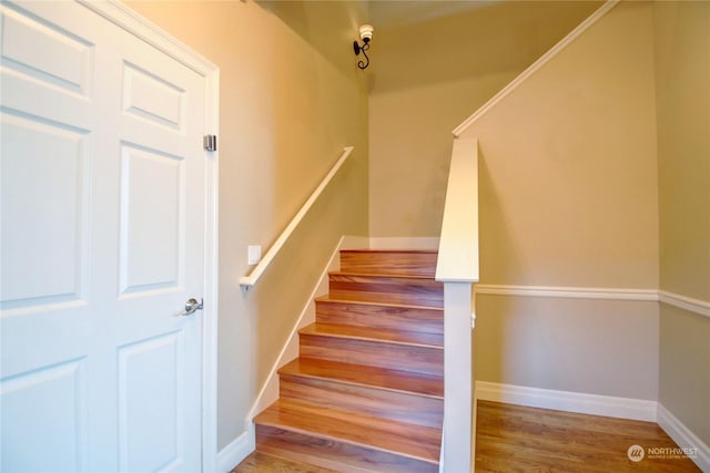 stairs featuring hardwood / wood-style floors