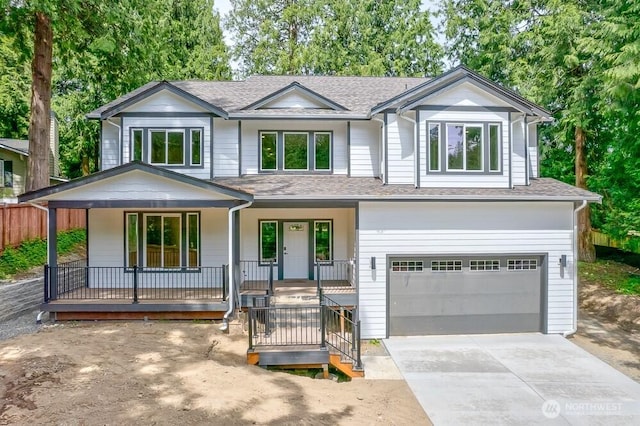 view of front of house featuring a porch, roof with shingles, a garage, and driveway