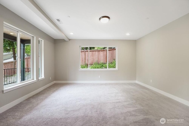 carpeted spare room with plenty of natural light, baseboards, and recessed lighting