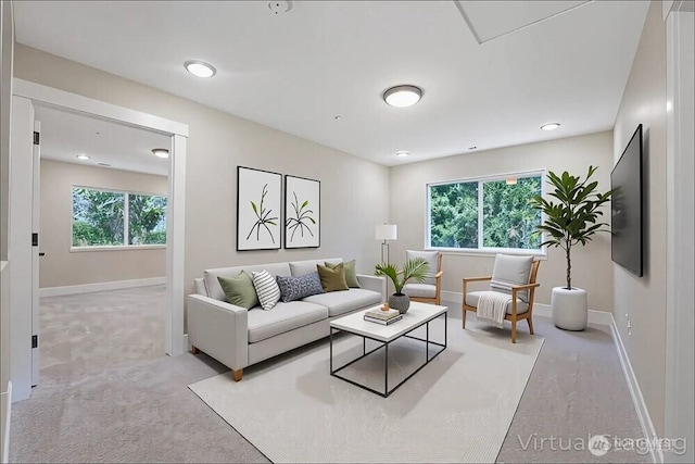 living area featuring carpet floors, baseboards, and recessed lighting