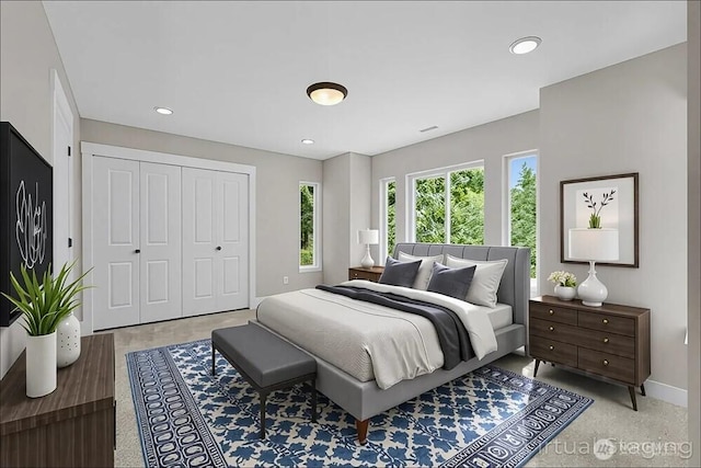 bedroom featuring baseboards, a closet, and recessed lighting