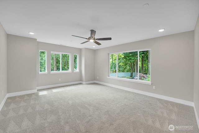 empty room with healthy amount of natural light, baseboards, carpet flooring, ceiling fan, and recessed lighting