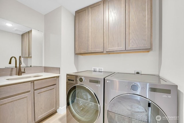 laundry room with separate washer and dryer and cabinet space