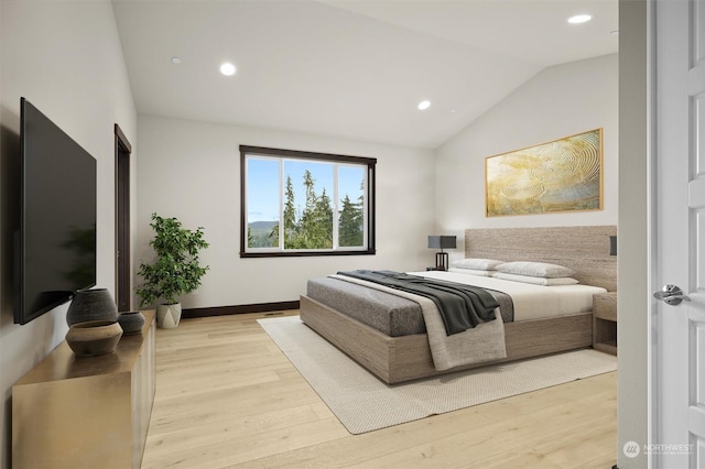 bedroom featuring light hardwood / wood-style flooring and vaulted ceiling