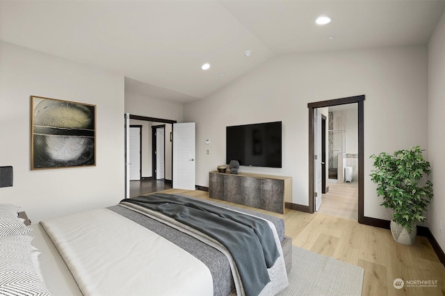 bedroom featuring light hardwood / wood-style flooring and lofted ceiling