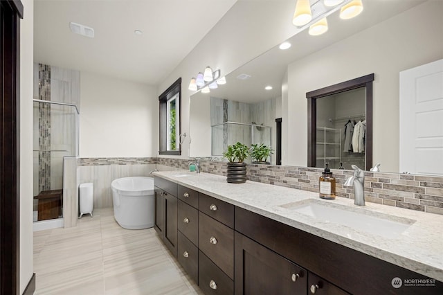 bathroom with tile patterned floors, vanity, and separate shower and tub