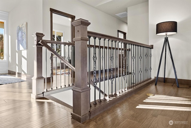 stairway with hardwood / wood-style flooring