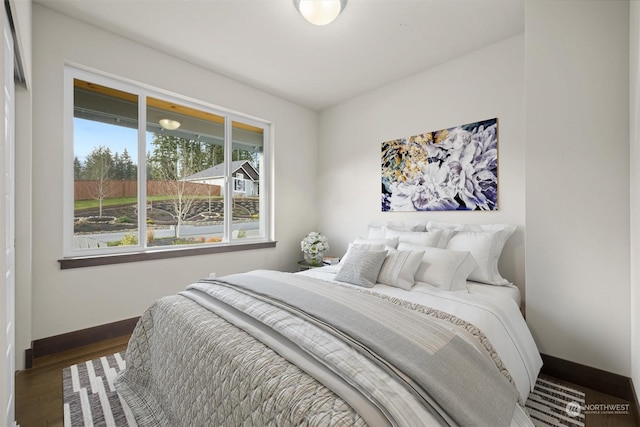 bedroom with dark wood-type flooring