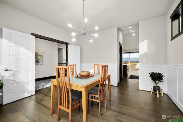 dining space featuring dark hardwood / wood-style floors and a notable chandelier