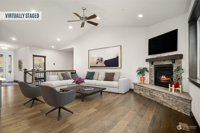 living room featuring a fireplace, hardwood / wood-style floors, and vaulted ceiling