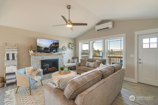 living room featuring ceiling fan, light hardwood / wood-style flooring, an AC wall unit, vaulted ceiling, and a fireplace