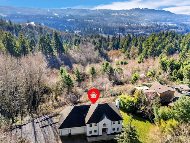 aerial view with a mountain view and a wooded view