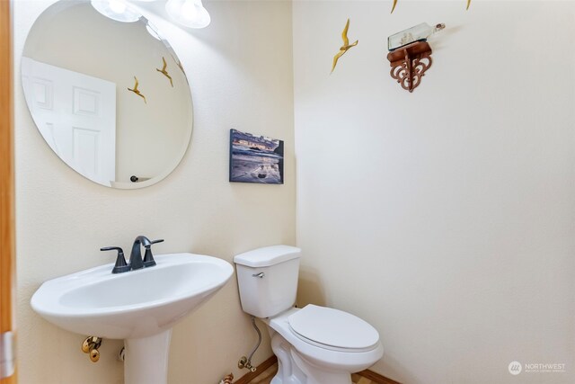 bathroom featuring toilet and a sink