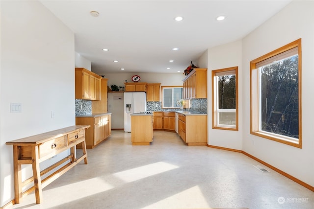 kitchen with a center island, visible vents, backsplash, and finished concrete flooring