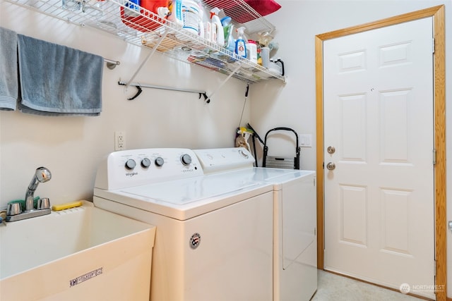 laundry room featuring laundry area, independent washer and dryer, and a sink