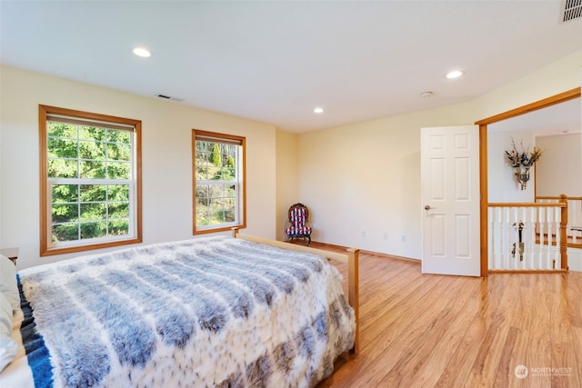 bedroom with recessed lighting, light wood-style floors, visible vents, and baseboards