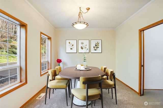 dining area featuring visible vents, light carpet, and crown molding