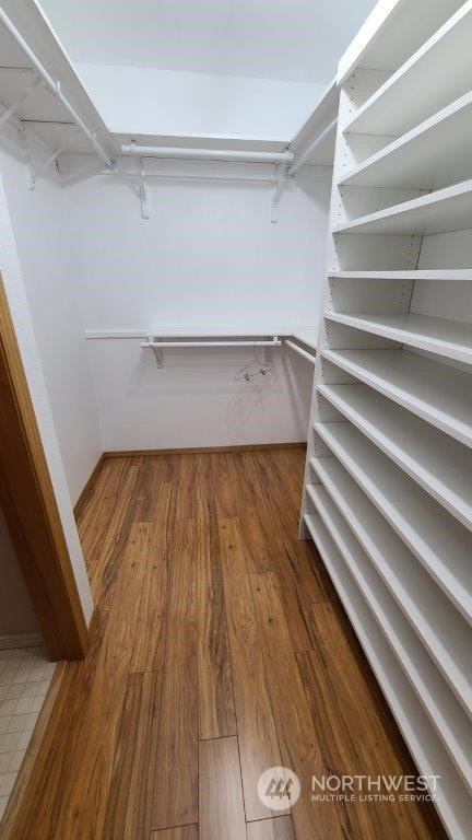 spacious closet with wood finished floors