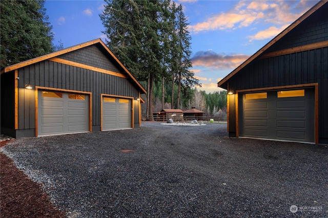 view of garage at dusk