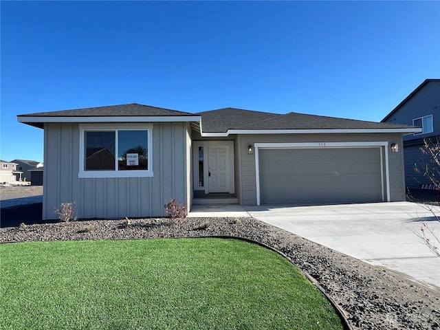 view of front of home with a garage and a front lawn