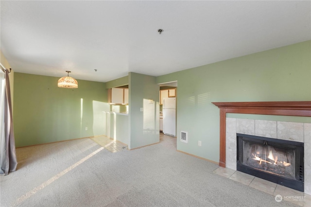 unfurnished living room featuring light carpet and a fireplace