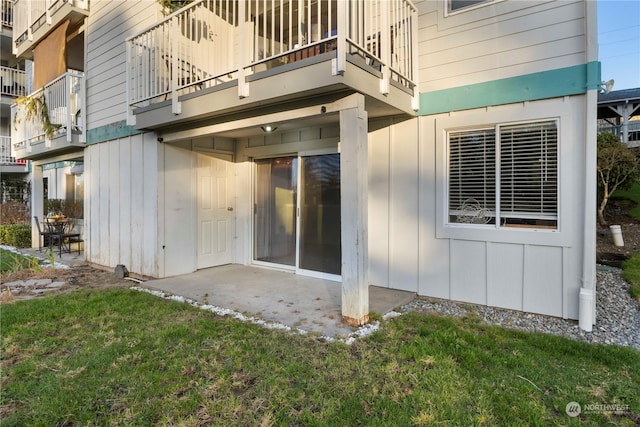 rear view of house with a yard and a patio