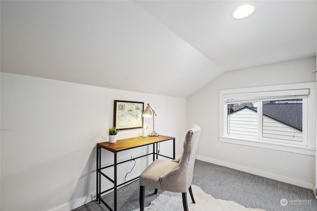 carpeted office space featuring vaulted ceiling