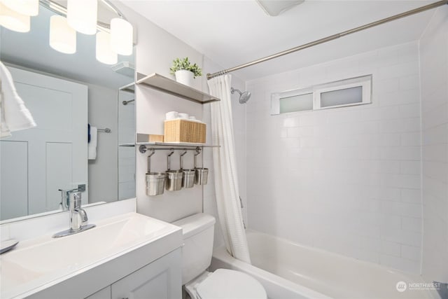 full bathroom featuring toilet, shower / bath combo with shower curtain, and vanity