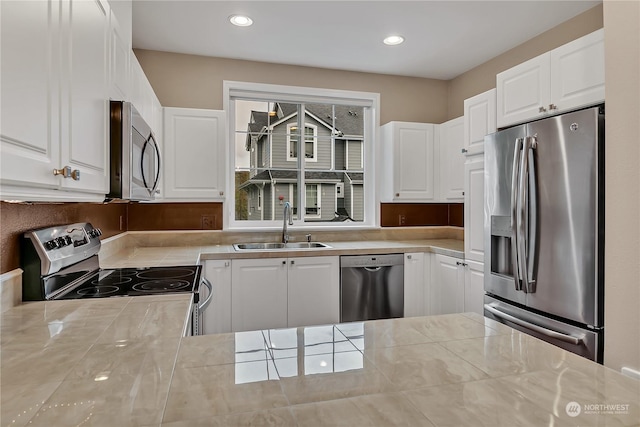 kitchen featuring white cabinets, stainless steel appliances, and sink