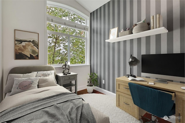 bedroom with vaulted ceiling and multiple windows