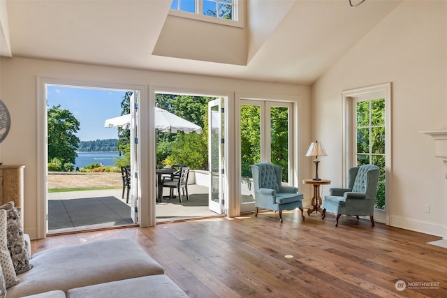 entryway with hardwood / wood-style flooring and a water view