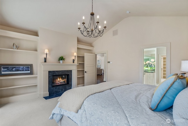 bedroom with a fireplace, an inviting chandelier, vaulted ceiling, and light carpet