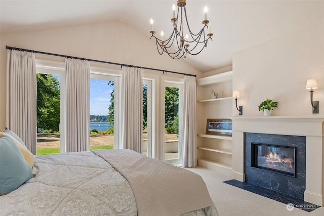 bedroom with a high end fireplace, multiple windows, access to outside, and a water view