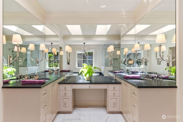 kitchen featuring sink, beamed ceiling, a skylight, dark stone counters, and pendant lighting