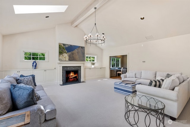 carpeted living room with high vaulted ceiling, a notable chandelier, beamed ceiling, and a skylight