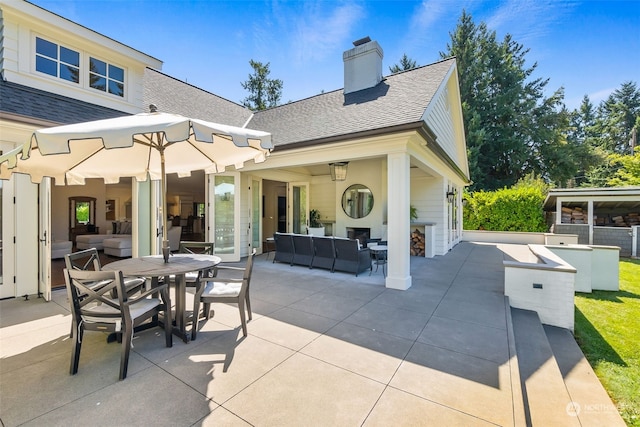 view of patio / terrace with a bar and outdoor lounge area