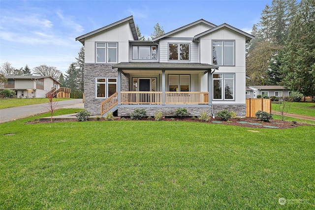 view of front of home featuring covered porch and a front yard