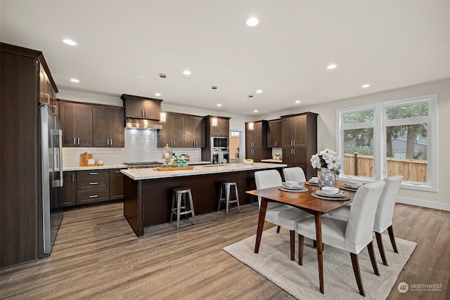 dining space featuring light hardwood / wood-style flooring and sink