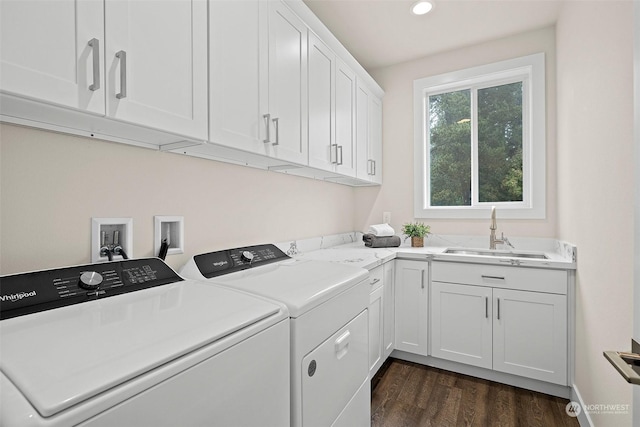 laundry area with washer and clothes dryer, dark hardwood / wood-style floors, sink, and cabinets