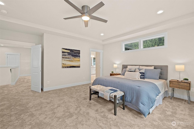 carpeted bedroom featuring ceiling fan and ensuite bath