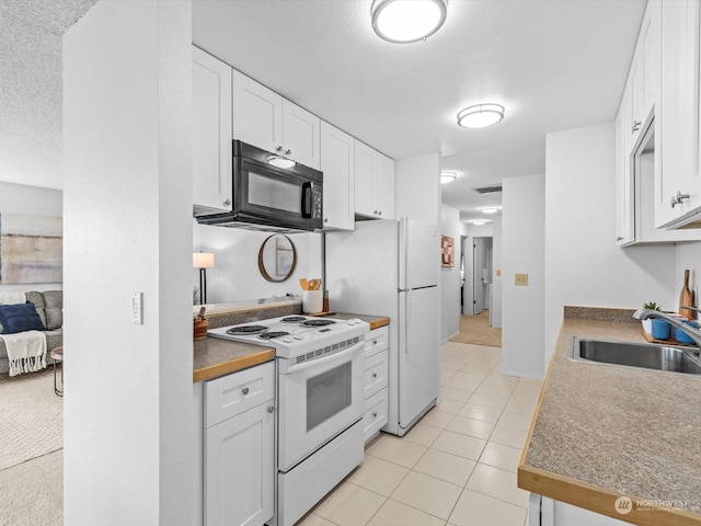 kitchen featuring white cabinetry, sink, white appliances, and light tile patterned flooring